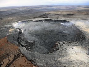 In this April 23, 2018 photo provided by the U.S. Geological Survey, Kilauea Volcano's Puu Oo vent is shown in Hawaii Volcanoes National Park on the Big Island. A series of earthquakes and the collapse of the crater floor at the Puu Oo vent could trigger a new eruption of lava. Officials from the U.S. Geological Survey's Hawaiian Volcano Observatory said Tuesday, May 1, 2018 that activity over the past 24 hours could lead to a new breakout on the east side of the Big Island volcano.