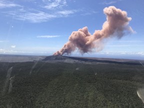 In this photo provided by the U.S. Geological Survey, red ash rises from the Puu Oo vent on Hawaii's Kilauea Volcano after a magnitude-5.0 earthquake struck the Big Island, Thursday, May 3, 2018 in Hawaii Volcanoes National Park. The temblor Thursday is the latest and largest in a series of hundreds of small earthquakes to shake the island's active volcano since the Puu Oo vent crater floor collapsed and caused magma to rush into new underground chambers on Monday. Scientists say a new eruption in the region is possible.