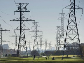 Hydro towers are seen over a golf course in Toronto on Wednesday, November 4, 2015.Hydro One says its first-quarter profit rose to $222 million, which was up 33 per cent from the same time last year. In late April, Kathleen Wynne’s government called on the company, which was partially privatized in 2015, to review its compensation scheme, and said it would abstain from a vote on the matter at an annual meeting being held today.