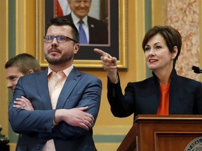 In this Jan. 8, 2018, photo Iowa Gov. Kim Reynolds does a walk through in the Iowa House chambers with deputy chief of staff Tim Albrecht, left, at the Statehouse in Des Moines, Iowa, before her Condition of the State address the next day. Albrecht has been hired by Apple months after helping promote a $208 million incentive package for the company's planned Iowa data center as a good deal for taxpayers. Albrecht departed as Reynolds' deputy chief staff, then began as manager of strategic initiatives for Apple in March.