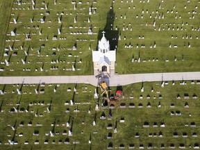 FILE - In this Aug. 9, 2017 file photo, workers dig a new grave at a church cemetery in New Vienna, Iowa. Preliminary data released on Wednesday, May 23, 2018 shows U.S. death rates rose again last year, indicating that 2017 likely will mark the third straight decline in American life expectancy.