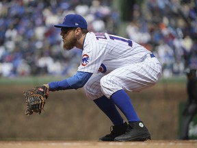 FILE - In this April 10, 2018, file photo, Chicago Cubs first baseman Ben Zobrist plays in place of the injured Anthony Rizzo during the team's baseball game against the Pittsburgh Pirates at Wrigley Field in Chicago. Major League Baseball has warned Zobrist against wearing black cleats. Zobrist posted a letter from the league office on Instagram saying the cleats he wore May 2 against Colorado violated the collective bargaining agreement. MLB says they must be at least 51 percent blue--the Cubs' color--and warned he could be fined and disciplined if he doesn't comply. Zobrist says he has worn black cleats for day games at Wrigley Field the past two years to honor the game's past.