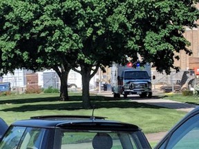 An emergency vehicle appears outside Dixon High School Wednesday, May 16, 2018 in Dixon, Ill. Officials say a police officer has shot and wounded a gunman at a northern Illinois high school. The Dixon city manager Danny Langloss says police confronted a former male student with a gun on school property about 8 a.m. Wednesday. Langloss says the gunman shot at an officer who returned fire and hit him. He is in custody with what Langloss described as non-life-threatening injuries.