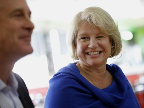 In this July 13, 2016, photo, Susan Bayh listens as husband Evan Bayh, the former two-term governor and two-term senator, speaks about why he has decided to seek re-election in the Senate.