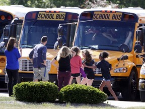 Students exits their buses as they return to class for the first time at Noblesville West Middle School in Noblesville, Ind., Wednesday, May 30, 2018.  Noblesville Schools' spokeswoman Marnie Cooke says it will operate on the same shortened schedule as the district's final two days of classes Thursday and Friday. Cooke says the school will focus on counseling and "team building" over the final three days of the school year.