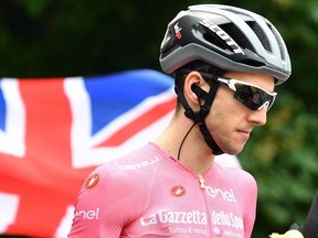 Britain's Simon Yates wears the pink jersey of the overall leader as he gets ready to start the 17th stage of the Giro d'Italia cycling race, from Riva del Garda to Iseo, Italy, Wednesday, May 23, 2018.