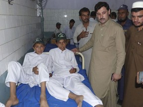 Pakistani family members visit studentsin a hospital that were injured in stampede following an earthquake, in Bannu, Pakistan, Wednesday, May 9, 2018. An official says a magnitude 5.5 earthquake has rattled northwest Pakistan, causing panic but there's no immediate word about damage or casualties.