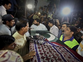 Family members and others carry the casket of Sabika Sheikh, Pakistani exchange student killed in a mass shooting at a high school in Texas, upon arrival at her home in Karachi, Pakistan, Wednesday, May 23, 2018. Her body has arrived in the port city of Karachi, where her family lives.