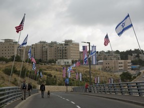 Security officers walk on a road leading to the US Embassy compound ahead the official opening in Jerusalem, Sunday, May 13, 2018. Monday's opening of the U.S. Embassy in contested Jerusalem, cheered by Israelis as a historic validation, is seen by Palestinians as an in-your-face affirmation of pro-Israel bias by President Donald Trump and a new blow to frail statehood dreams.
