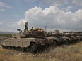 Israeli tanks take position near the Syrian border in the Israeli-annexed Golan Heights on May 9, 2018.