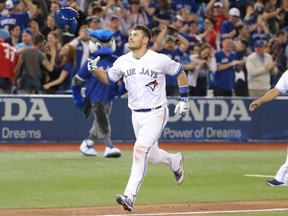 Luke Maile of the Toronto Blue Jays flips his batting helmet as he circles the bases following his extra-inning, two-run homer against the Boston Red Sox in MLB action Friday at Rogers Centre. Maile had a pair of homers in a 5-3 Jays' victory.