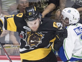 Hamilton Bulldogs defenceman Riley Stillman (61) fights for control of the puck with Swift Current Broncos forward Beck Malenstyn (19) during first period Memorial Cup action in Regina on Monday, May 21, 2018.