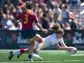 Canada's Breanne Nicholas jumps to score a try as Spain's Amaia Erbina looks on during the World Rugby Women's Sevens Series in Langford, B.C., Saturday, May, 12, 2018.