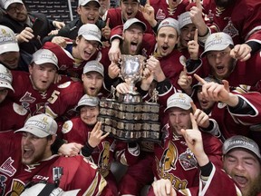 Members of the QMJHL's Acadie-Bathurst Titan pose with the Memorial Cup after defeating the Regina Pats on Sunday, May 27, 2018.