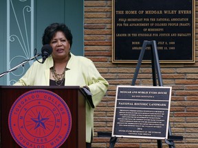Reena Evers-Everett, daughter of civil rights leaders Medgar and Myrlie Evers, delivers reflections on behalf of her family before the National Park Service presented a bronze plaque, right, showing the Jackson, Miss., Evers' home as a national historic landmark, Thursday, May 24, 2018. As the Mississippi NAACP's first field secretary beginning in 1954, Medgar Evers led voter registration drives and boycotts to push for racial equality. He was assassinated in June 1963 outside the family's modest ranch-style home.