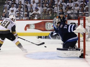 Jonathan Marchessault of the Vegas Golden Knights scores the second of his two goals on the night past Connor Hellebuyck of the Winnipeg Jets during Game 2 action in the Western Conference final Monday in Winnipeg. The Golden Knights won 3-1 to tie the series at 1-1 heading to Vegas for the next two games.
