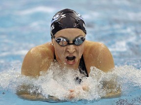 FILE - In this Dec. 6, 2008, file photo, Ariana Kukors swims to win the Women's 200-yard breaststroke finals during the 2008 USA Swimming Short Course National Championships at the Georgia Tech Aquatic Center in Atlanta. Olympic swimmer Kukors Smith sued USA Swimming on Monday, May 21, 2018, alleging the sport's national governing body knew her former coach sexually abused her as a minor and covered it up. Kukors Smith filed the lawsuit in Superior Court in Orange County, Calif. She alleges Sean Hutchison, who began coaching her at a swim club near Seattle, groomed her for sexual abuse when she was 13, started touching and kissing her when she was 16 and engaging in sexual activity with her when she was 17.