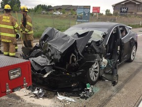 FILE - In this Friday, May 11, 2018, file photo released by the South Jordan Police Department shows a traffic collision involving a Tesla Model S sedan with a Fire Department mechanic truck stopped at a red light in South Jordan, Utah. The Tesla that crashed while in Autopilot mode accelerated in the seconds before it smashed into the stopped firetruck, according to a police report obtained by The Associated Press. Two people were injured. Data from the Model S electric vehicle show it picked up speed for 3.5 seconds before crashing into the firetruck the report said. The driver manually hit the brakes a fraction of a second before impact. (South Jordan Police Department via AP,File)
