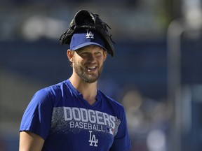 Los Angeles Dodgers pitcher Clayton Kershaw attends batting practice prior to a baseball game against the San Diego Padres, Friday, May 25, 2018, in Los Angeles.