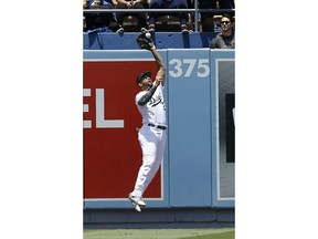 Los Angeles Dodgers left fielder Matt Kemp leaps for but cannot catch a ball hit for a double by San Diego Padres' Jose Pirela during the first inning of a baseball game in Los Angeles, Sunday, May 27, 2018.