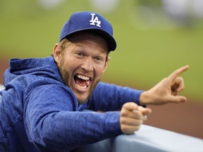 Los Angeles Dodgers pitcher Clayton Kershaw jokes around in the dugout prior to a baseball game against the San Diego Padres, Friday, May 25, 2018, in Los Angeles.