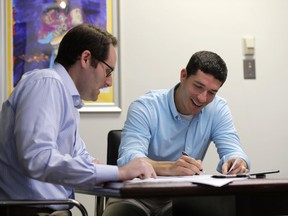Michael Finkelstein works in his law office with attorney Scott Sternberg in New Orleans, Friday, May 18, 2018. Finkelstein, a high school student at Benjamin Franklin High School when Hurricane Katrina hit in 2005, was forced to relocate to Austin, Texas, now lives in New Orleans. This Sunday, officials at Franklin are welcoming back the class of 2006 and offering them honorary diplomas as a way to remember a group that was thrown across the country at a time when they should have been worried about homecoming and college applications.