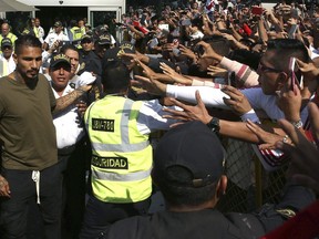 Peru captain Paolo Guerrero, left, is greeted by fans as he arrives in Lima, Peru, Tuesday, May 15, 2018. The global footballers' union wants FIFA's help to review anti-doping rules after Guerrero was banned from the World Cup for a positive test for cocaine caused by contaminated tea. FIFPro says a 14-month ban barring the 34-year-old Guerrero from his World Cup debut is "unfair and disproportionate."