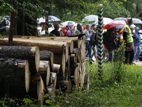 FILE - In this Sunday, Aug. 13, 2017 file photo, people take part in a protest against large-scale government logging in the Bialowieza Forest, Poland. A court in eastern Poland on Friday, May 11, 2018 has acquitted environmentalists who had blocked government-ordered logging in one of Europe's last pristine forests. In June, the activists chained themselves to heavy equipment, thus blocking the large-scale felling of trees in the Bialowieza Forest. The court acquitted the environmentalists, saying they had acted in the public interest.