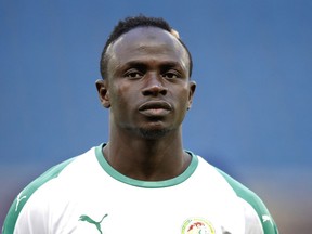 FILE - In this Tuesday, March 27, 2018 file photo, Senegal's Sadio Mane listens to national anthem prior to their friendly soccer match against Bosnia and Herzegovina at the Oceane stadium in Le Havre, northern France. Senegal has named its final 23-man squad for the World Cup, with Liverpool forward Sadio Mane leading a group that also includes key defender Kalidou Koulibaly of Napoli and midfielder Cheikh Kouyate of West Ham.