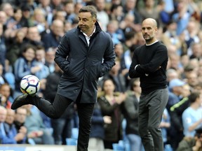 FILE - In this Sunday, April 22, 2018 file photo, Swansea manager Carlos Carvalhal, left, kicks the ball during their English Premier League soccer match against Manchester City at Etihad stadium in Manchester, England. Manager Carlos Carvalhal has left Swansea after the English Premier League club decided not to renew his contract on Friday, May 18, 2018. Swansea was relegated last Sunday after seven years in the topflight.