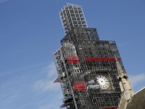 FILE - In this Tuesday, April 17, 2018 file photo, scaffolding surrounds the world famous clock on the Queen Elizabeth Tower, which also holds the bell known as Big Ben, as it continues to be refurbished as part of the overall 3.5 billion pound repair of the Palace of Westminster, in London. British police have arrested an intruder who scaled scaffolding and got onto the roof of Parliament. London's Metropolitan Police force says officers were called late in the morning of Wednesday, May 30 "to reports of a man acting suspiciously" near an entrance to the building. The man then climbed a fence and scaled scaffolding to the roof.