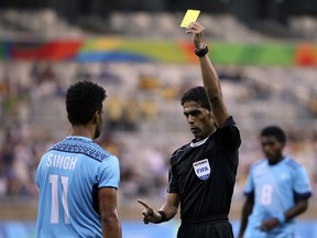FILE - In this Wednesday, Aug. 10, 2016 file photo, Fiji's Alvin Singh is yellow carded by referee Fahad Al Mirdasi of Saudi Arabia during a group C match of the men's Olympic football tournament between Germany and Fiji at the Mineirao Stadium in Belo Horizonte, Brazil. A World Cup-bound referee, who is one of Asian football's most experienced officials, has been placed under investigation in Saudi Arabia. The Saudi Football Federation removed Fahad Al Mirdasi from overseeing the King's Cup final on Saturday, May 12, 2018 after referred him to administrative investigators.