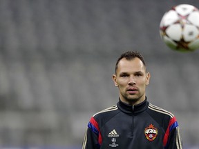 FILE - In this Tuesday Dec. 9, 2014 file photo, CSKA's Sergei Ignashevich watches the ball during a training session prior to their Champions League soccer match against FC Bayern Munich, in Munich, southern Germany. Russia has cut from its World Cup squad a player who faced a doping investigation. The Russian Football Union says defender Ruslan Kambolov picked up a calf muscle injury during a game on Sunday, May 13, 2018. He has been replaced by the 38-year-old veteran Sergei Ignashevich, who is coming out of international retirement.