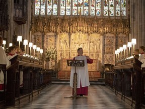 In this picture taken on Monday, May 14, 2018, James Vivian, Director of Music at St George's Chapel, directs the St. George's Chapel Choir during a rehearsal before evensong and ahead of the wedding of Prince Harry and Megan Markle this weekend, in Windsor, England.