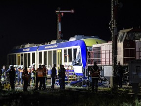 Emergency services attend the scene after a cargo train and a passenger train collided in Aichach, 50 Kilometers west of Munich, southern Germany, Monday, May 7, 2018. At least two people have been killed.