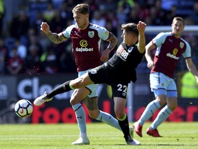 Burnley's Jeff Hendrick, left, and AFC Bournemouth's Emerson Hyndman battle for the ball during their English Premier League soccer match at Turf Moor, Burnley, England, Sunday, May 13, 2018.