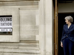 British Prime Minister Theresa May pauses to pose for photographers as she leaves after voting in local council elections at a polling station at Methodist Central Hall in London, Thursday, May 3, 2018.  Britain goes to the polls Thursday to elect local area officials.