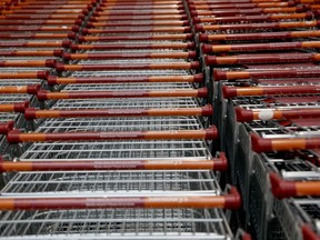 Trolleys stand stacked together inside the Sainsbury's flagship store in the Nine Elms area of London, Monday, April 30, 2018. Sainsbury's has agreed to buy Walmart's U.K. unit, Asda, for 7.3 billion pounds ($10.1 billion) in cash and stock in a deal that would create Britain's largest supermarket chain and marks a profound shift in the country's grocery market.