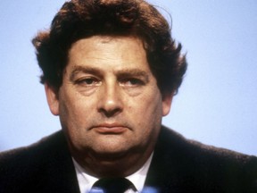 FILE - In this Oct. 9, 1986 file photo Britain's Finance Minister Nigel Lawson pauses at the annual conference of the Conservative Party in Bournemouth, England. A leading campaigner for Britain's exit from the European Union has been accused of hypocrisy after applying for permanent residency in France. Former U.K. Treasury chief Nigel Lawson told newspaper The Connexion that he is applying for a permanent residency card, known as a carte de sejour.