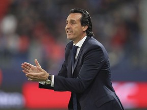 FILE  - In this Saturday, May 19, 2018 file photo, PSG head coach Unai Emery claps,  during the League One soccer match between Caen and Paris Saint-Germain at the Michel d'Ornano stadium in Caen, western France. The last time Arsenal unveiled a new manager, social media didn't exist. On Wednesday, May 23, 2018 the north London club announced the appointment of Unai Emery on Twitter.