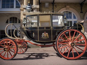 The Scottish State Coach, which will be used in the case of wet weather, for the wedding of Britain's Prince Harry and Meghan Markle, while it is prepared for the special day, in the Royal Mews at Buckingham Palace in London, Tuesday May 1, 2018.  Prince Harry and Meghan Markle will tie the knot at St. George's Chapel in Windsor, southern England on May 19, with about 600 guests and some 2,600 neighbours, staff and specially selected members of the public greeting the happy couple outside the chapel. The Ascot Landau open carriage will be used if it turns out to be a sunny day.