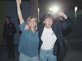 FILE - In this file photo dated Nov. 25, 1993, Paul and Linda McCartney pose for photographers at a news conference before a performance in Mexico City at Hermanos Rodriguez race track. The Victoria & Albert Museum in London, said Thursday May 3, 2018, that Paul McCartney has donated 63 photographs taken by his late wife Linda to the museum's new photography centre. The donated collection includes portraits of The Beatles, The Rolling Stones and Jimi Hendrix as well as family portraits.