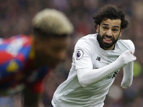 FILE - In this Saturday, March 31, 2018 file photo, Liverpool's Mohamed Salah runs past Crystal Palace's James Tomkins during the English Premier League soccer match between Crystal Palace and Liverpool at Selhurst Park stadium in London. Liverpool is set to play a 4-3-3 formation with free-scoring forward Mohamed Salah the star player this season, during the Champions League soccer final against Real Madrid on Saturday, May 26, 2018.