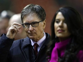 FILE - In this Tuesday, Feb. 10, 2015 file photo, Liverpool owner John Henry and his wife Linda Pizzuti arrive ahead of the English Premier League soccer match between Liverpool and Tottenham Hotspur at Anfield Stadium, Liverpool, England. John Henry is preparing for his first Champions League final as Liverpool owner. The game on Saturday May 24, 2018 against Real Madrid comes eight years after Henry led a takeover by the Boston Red Sox ownership group of a club on the brink of financial collapse.