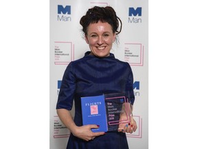 Polish author Olga Tokarczuk smiles after winning the Man Booker International prize 2018, Tuesday, May 22, 2018, for her book Flights, at the Victoria and Albert Museum in London.