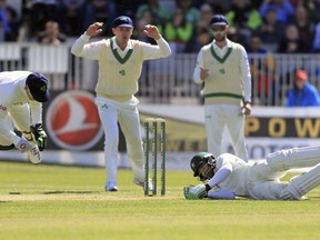 Ireland's Niall O'Brien, left, collides with Pakistan's Imam-ul-Haq on day two of the International Cricket Test Match between Ireland and Pakistan at The Village, Dublin, Saturday, May 12, 2018.