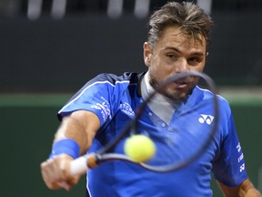 Switzerland's tennis player Stanislas Wawrinka returns a ball to Jared Donaldson of the United States during their second round match at the Geneva Open tournament in Geneva, Switzerland, Wednesday, May 23, 2018.