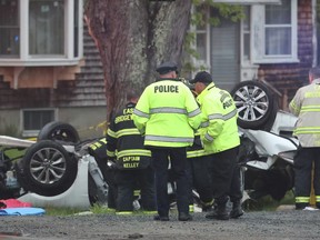 Police and firefighters investigate a multi fatal car crash in East Bridgewater, Mass., May 19, 2018. Police have identified teenagers killed in a Massachusetts car crash as local high school students. The five teens, all males, were traveling in one car in East Bridgewater when it crashed into a tree shortly after 4 p.m. Saturday.