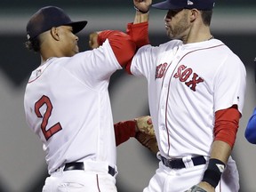 Boston Red Sox right fielder J.D. Martinez, right, and shortstop Xander Bogaerts celebrate after the Red Sox defeated the Oakland Athletics 6-4 during a baseball game at Fenway Park in Boston, Wednesday, May 16, 2018. Both Martinez and Bogaerts homered.