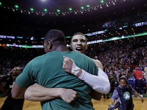 Boston Celtics forward Jayson Tatum, right, is embraced by Guerschon Yabusele after the Celtics the Philadelphia 76ers from the NBA basketball playoffs in Boston, Wednesday, May 9, 2018. Tatum scored 25 points as the Celtics won 114-112.